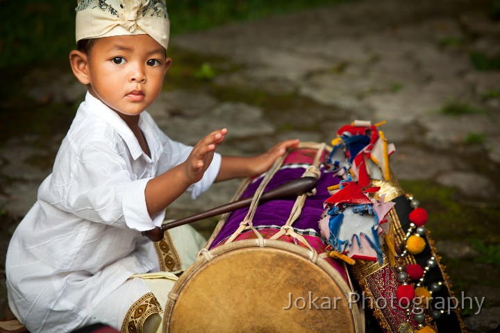 Pura_Dalem_20100803_188.jpg - 27. PURA DALEM, UBUD #5 - During a break in the performance of a gamelan orchestra at the Pura Dalem Odalan, Ubud, a young boy plays on his father’s kendang drum.